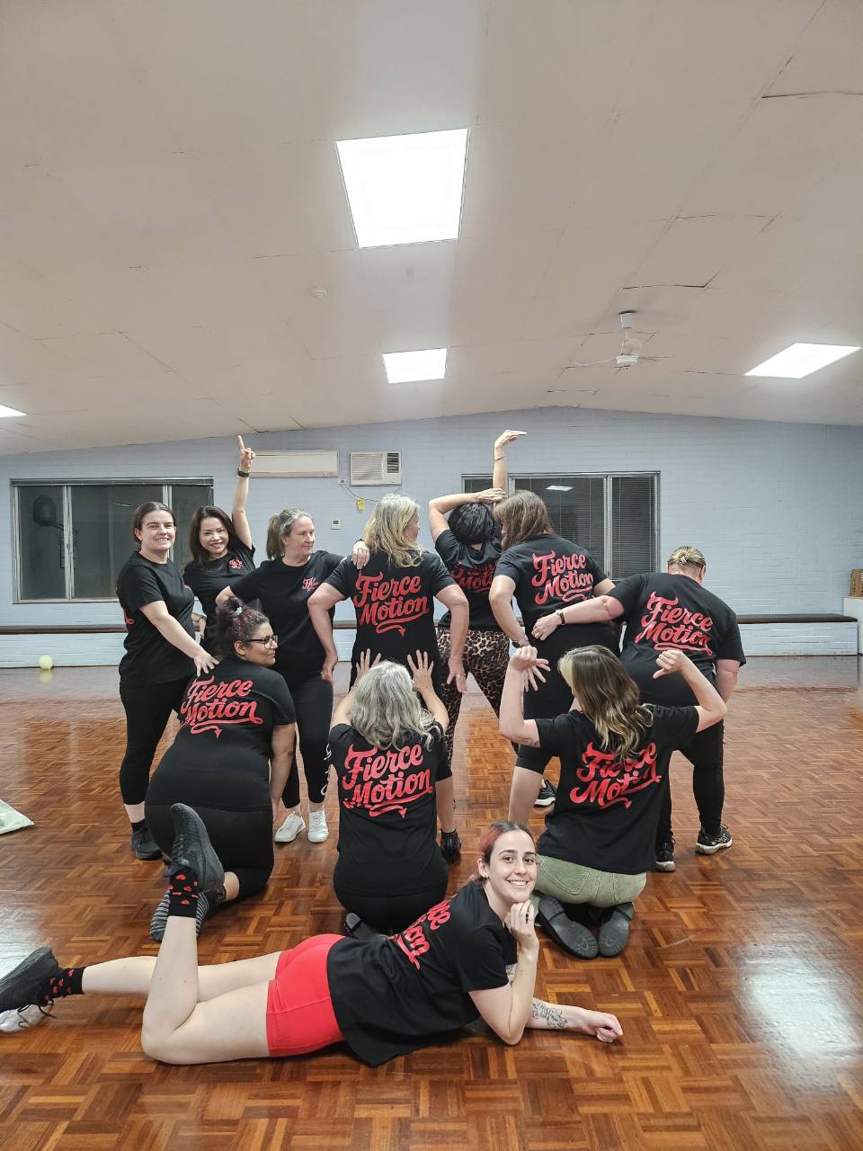 The Fierce Motion dance group together in their branded shirts